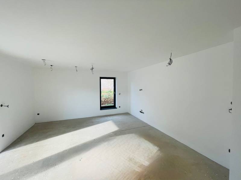 Windows and an empty room with white walls in a family house.