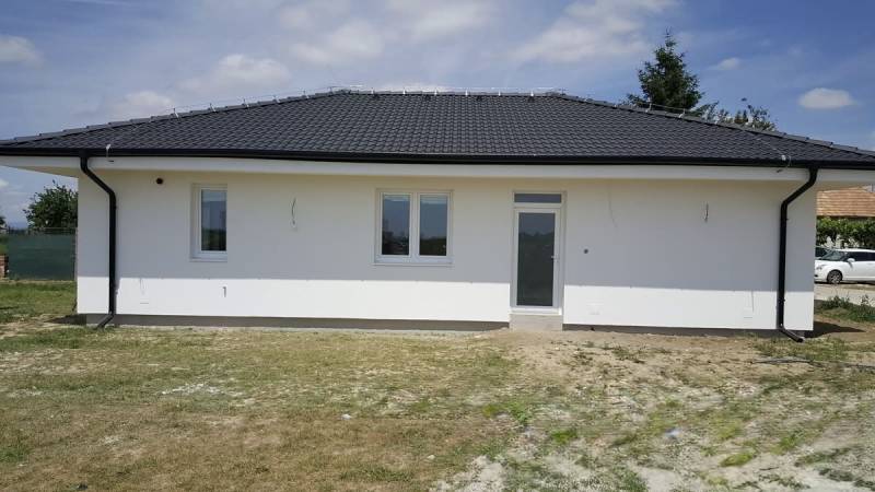 A family house in Western Slovakia with a gable roof and a white facade.
