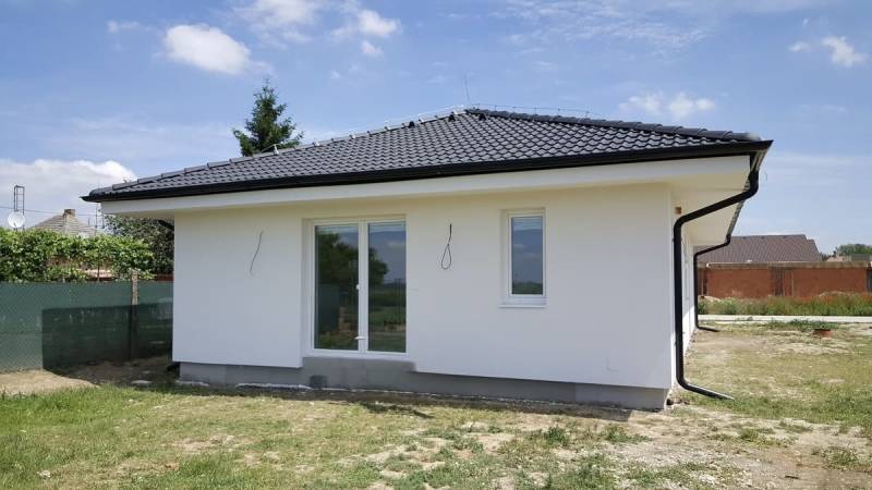A family house in Western Slovakia with a white facade and a sloped roof.