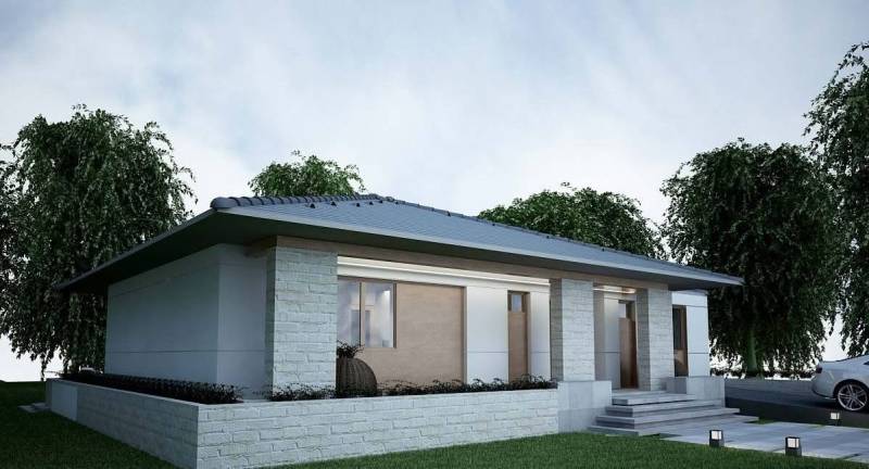 A family house in Western Slovakia with a gable roof and gray facade.