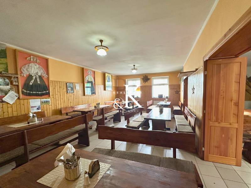 Rustic gastro spaces with wooden furnishings and decorations on the walls.