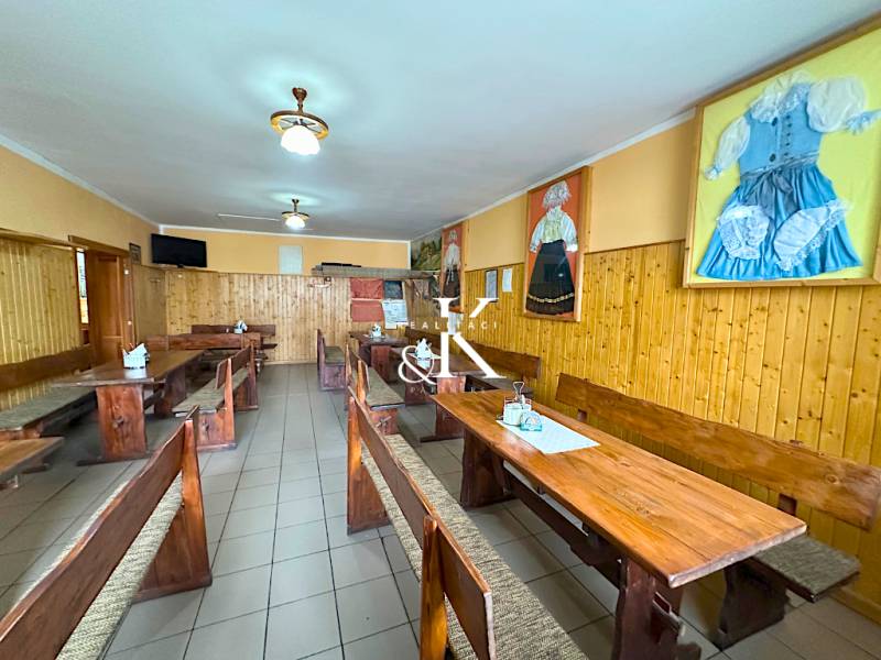 Traditional interior with wooden tables and chairs, decorations in dining areas.