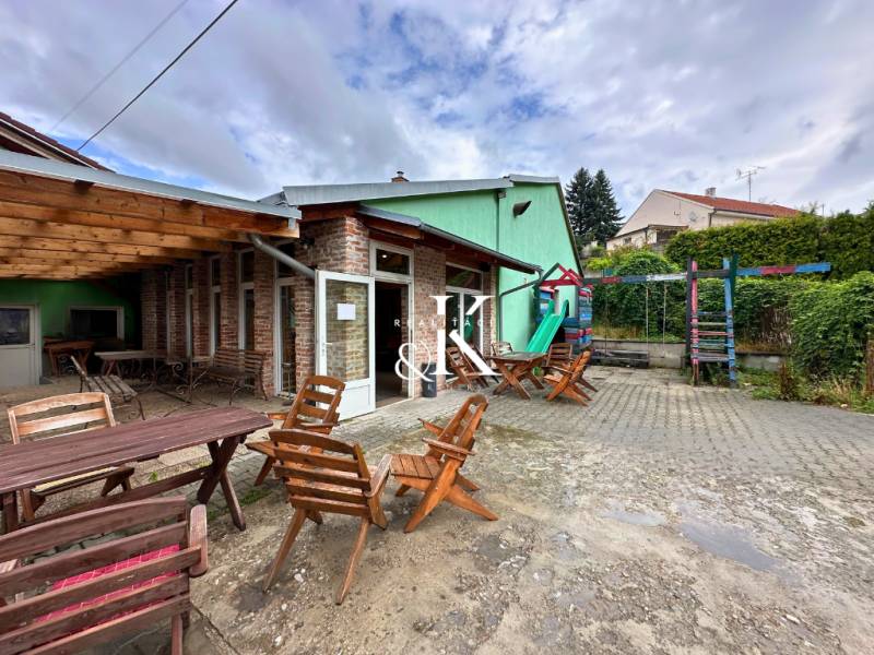 In Moravany nad Váhom, there are outdoor gastro areas with wooden seating and a playground.