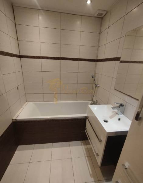 A bathroom with a bathtub and a sink in a 3-room apartment.