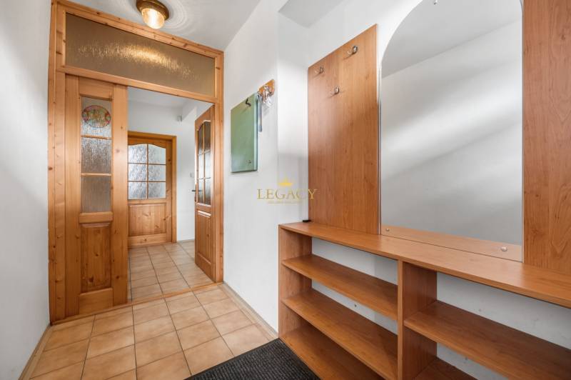 A hallway with built-in wooden furniture in a family house.