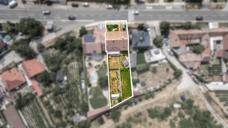 Aerial view of a family house in Vinosady with an adjacent garden and surroundings.