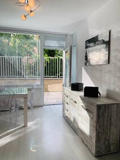 Bright living room in a 2-room apartment on Palisády Street with a view of the terrace.