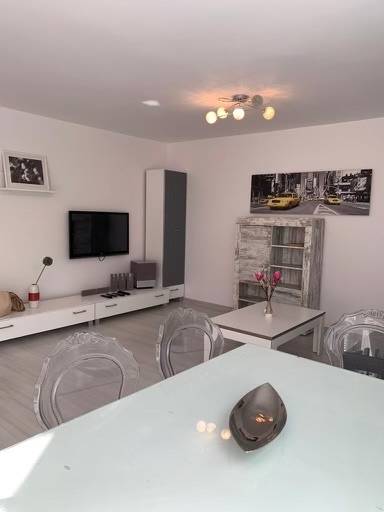 Living room in a 2-room apartment on Palisády Street with modern furniture and a painting.