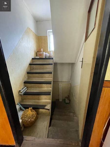 A staircase in a family house with wooden steps and storage space underneath.