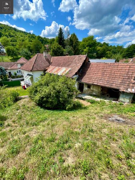 A family house in Horná Súča surrounded by greenery with a traditional red tile roof.