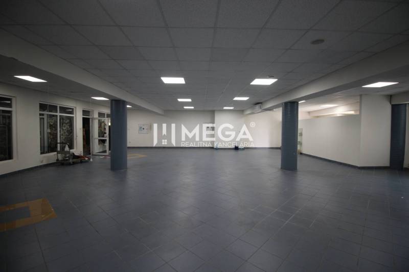 Spacious commercial spaces with tiled flooring and lighting.