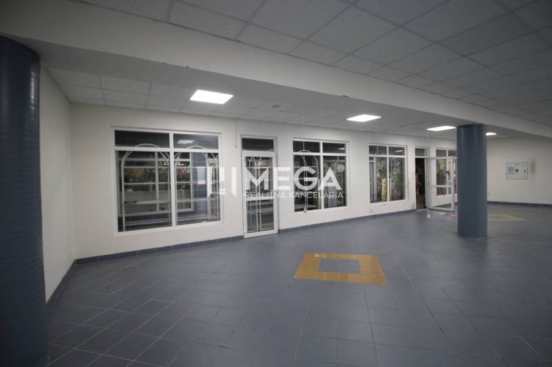 Commercial premises with tiled floors and glass walls.