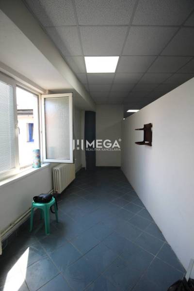 A narrow space with a window and a chair, ideal for commercial premises.