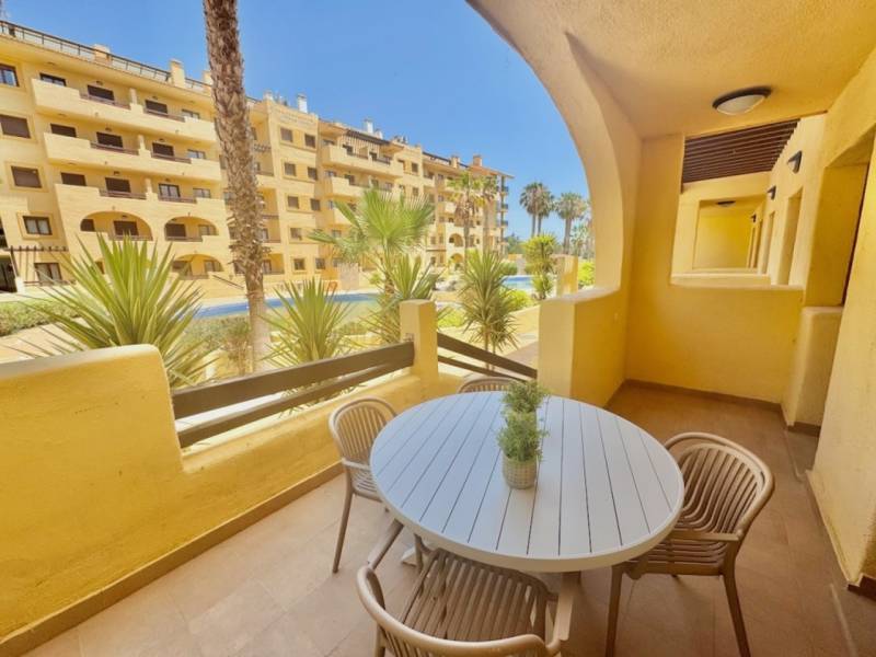 Recreational apartment in Los Alcázares with garden furniture and pool view.