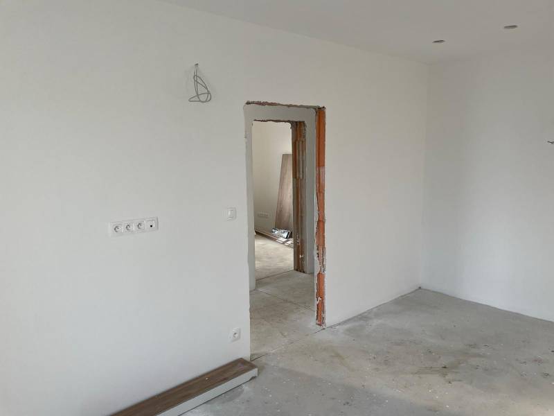 Construction of houses with white walls and unfinished interior details.