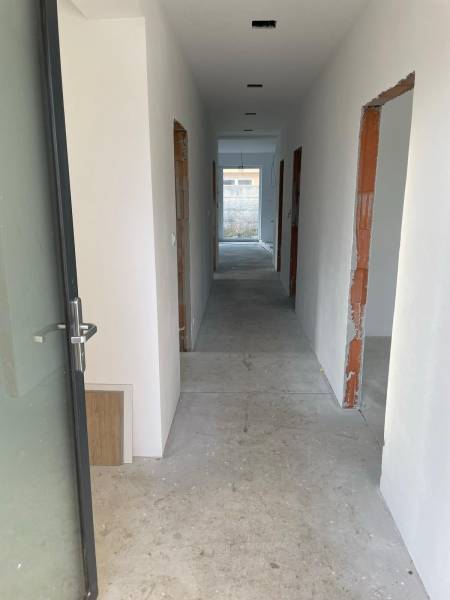 Corridor under construction with several rooms and raw walls, House construction.