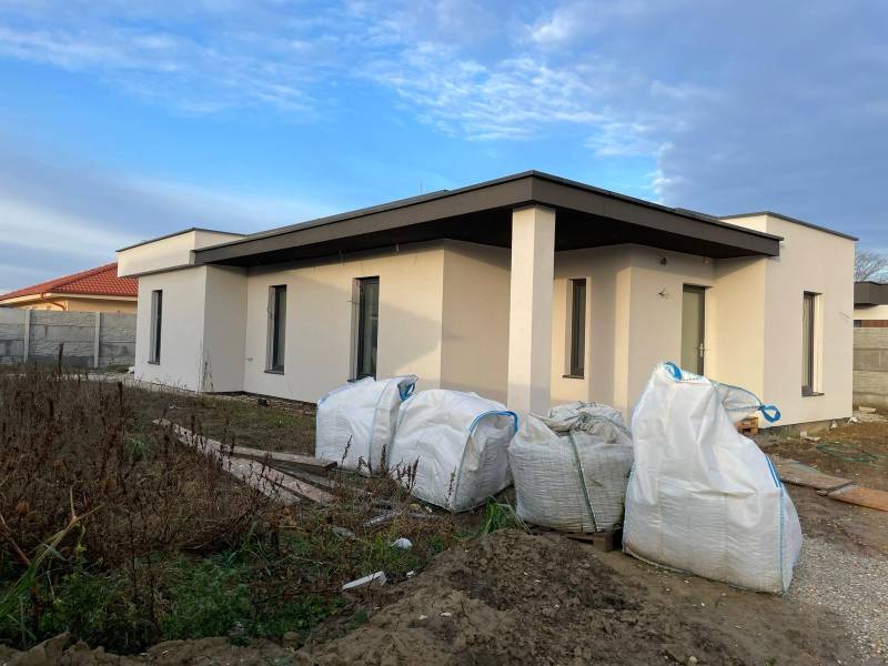 Construction of houses in Western Slovakia: new building with a flat roof and building material.