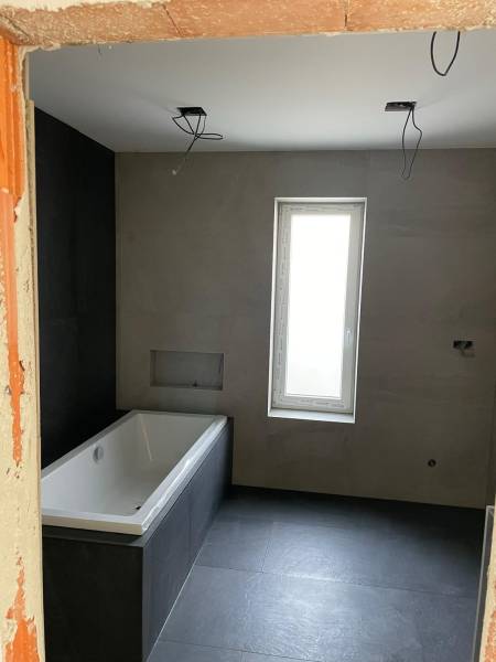 Building a bathroom with a bathtub and tiles, House construction.