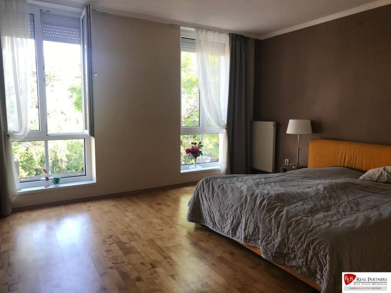 Bedroom in a 3-room apartment with wide windows and wooden flooring.