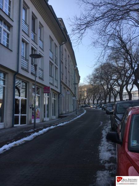 Winter street Zámocká in Bratislava with cars and buildings.