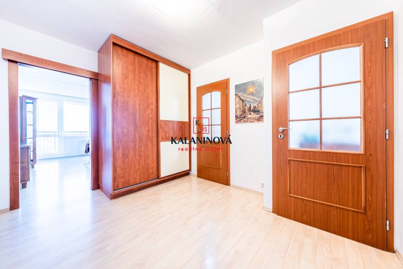 Wooden interior doors and a built-in wardrobe in a 3-room apartment with light flooring.