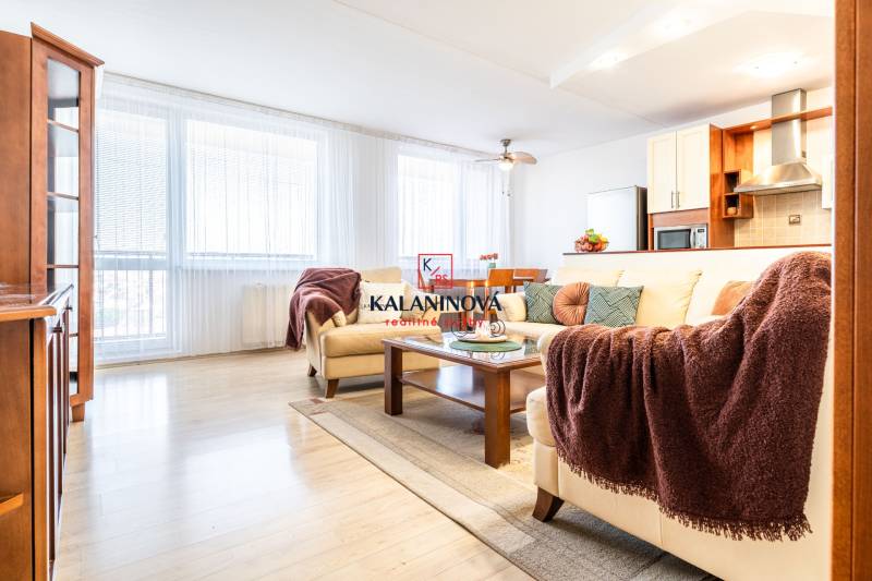 Living room in a 3-room apartment with a sofa, coffee table, and bookshelf.