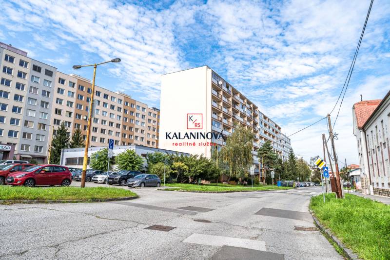 A view of apartment buildings in Košice on Žižkova Street, Juh district, with parking.