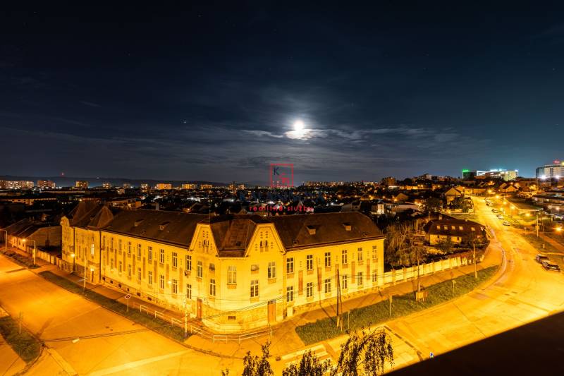 Night panorama of Košice - Juh district from Žižkova Street, illuminated buildings and road.