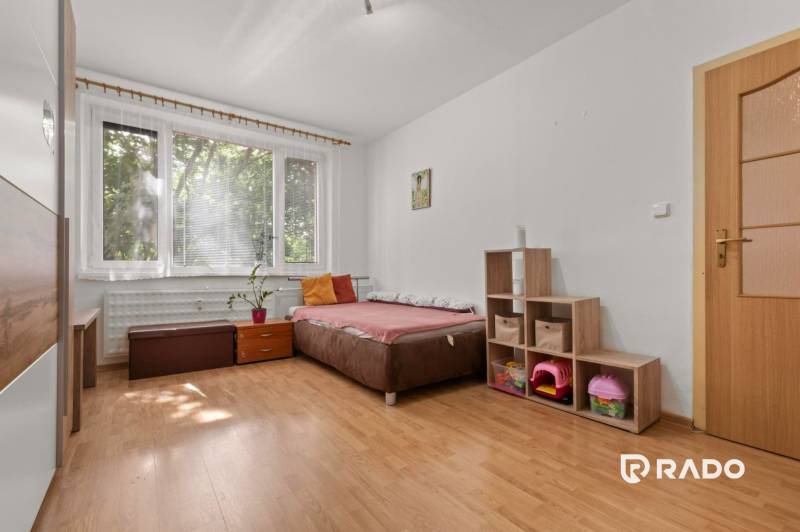 A bright room with a bed and storage space in a 3-room apartment.