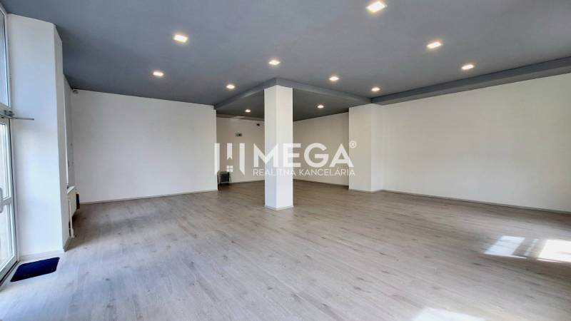 Bright office with flooring and columns, available for rent.