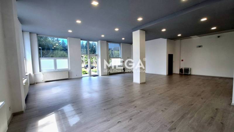 Spacious offices with laminate flooring, white walls, and large windows.
