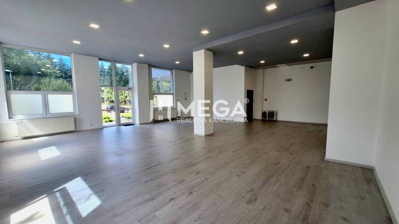Spacious offices with large windows and wooden flooring.