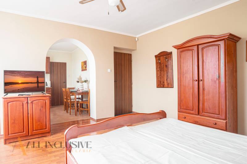 Interior of a room with wooden furniture and a television in hotels and guesthouses.