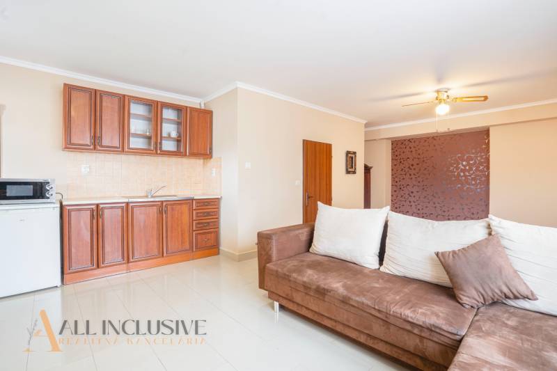 The interior of kitchenettes in hotels and guesthouses with a sofa and wooden cabinets.