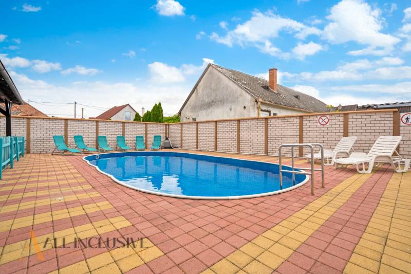 A pool with loungers in Veľký Meder, ideal for hotel and guesthouse visitors.