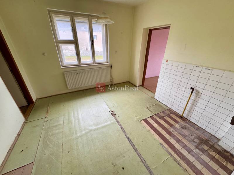 An older interior of a 3-room apartment on Lietavská Lúčka street, with tiles and a radiator under the window.