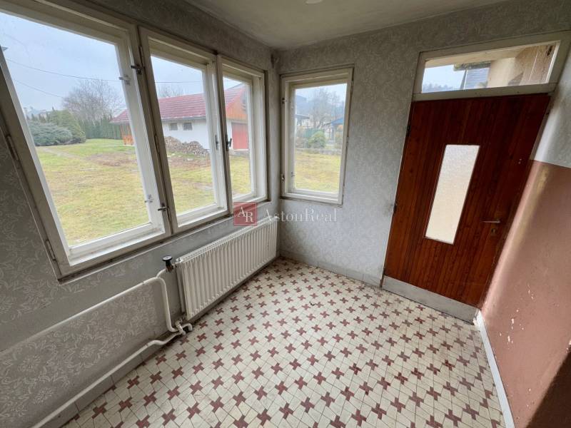 Interior with vintage tiles and large windows, view of the garden in Lietavská Lúčka.