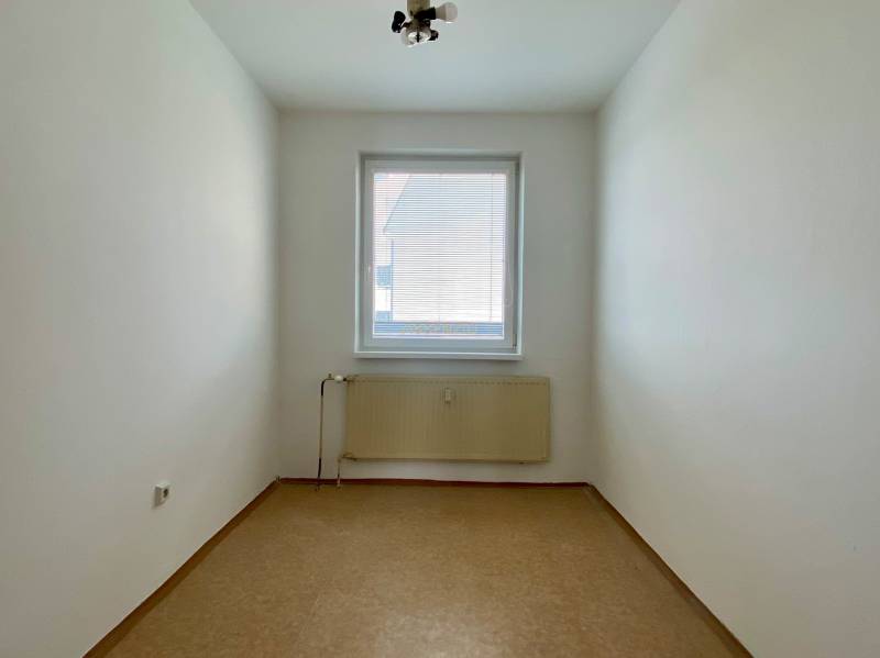 A small room with a window and a radiator in a 3-room apartment.