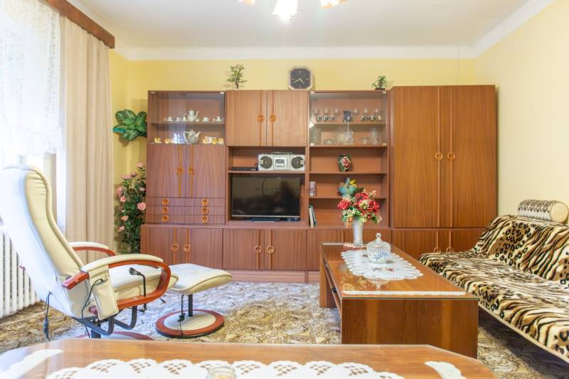 Retro living room in a family house with furniture, carpets, and accessories.