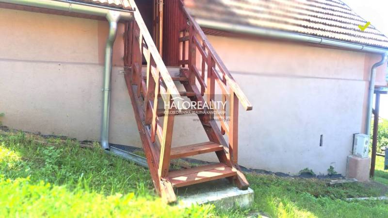 Wooden stairs leading to the veranda of the cottage in Hontianske Trsťany.