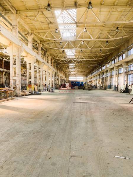 Industrial interior with high ceiling and steel construction. Warehouses and halls.