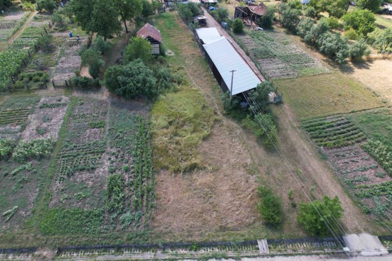 Aerial view of rural gardens and agricultural buildings in Štrkovec.
