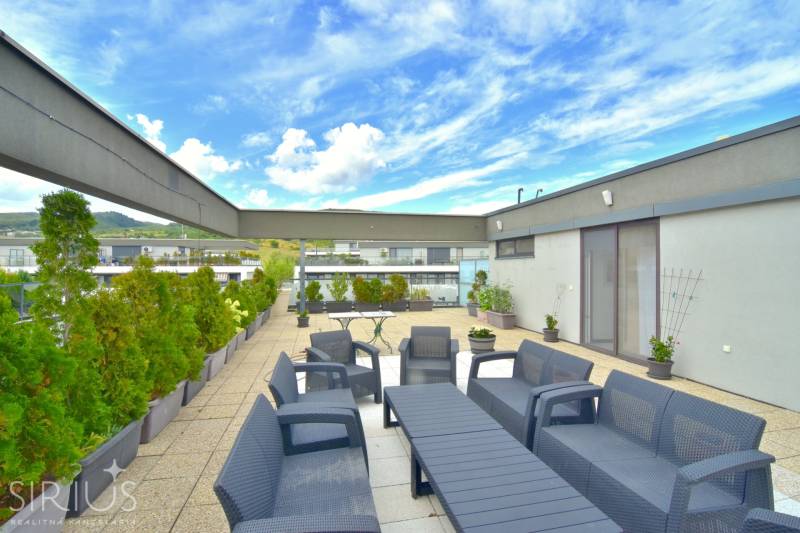 Terrace of a 4-room apartment on Pri vinohradoch Street in Bratislava - Rača with comfortable seating.