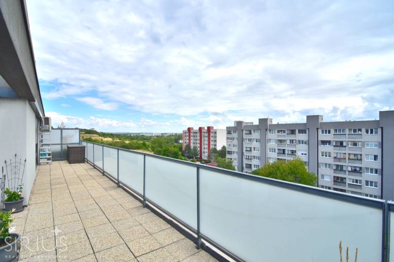 A spacious terrace at the 4-room apartment offers a view of Bratislava - Rača, Pri vinohradoch.