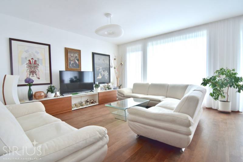 Bright living room with a sofa and decorations in a 4-room apartment.