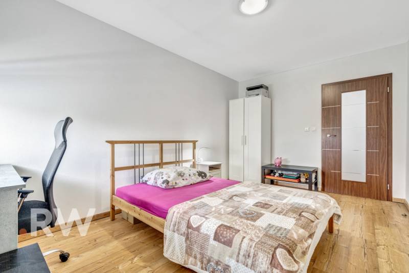 Bedroom in a 3-room apartment with a bed, desk, and wardrobe.