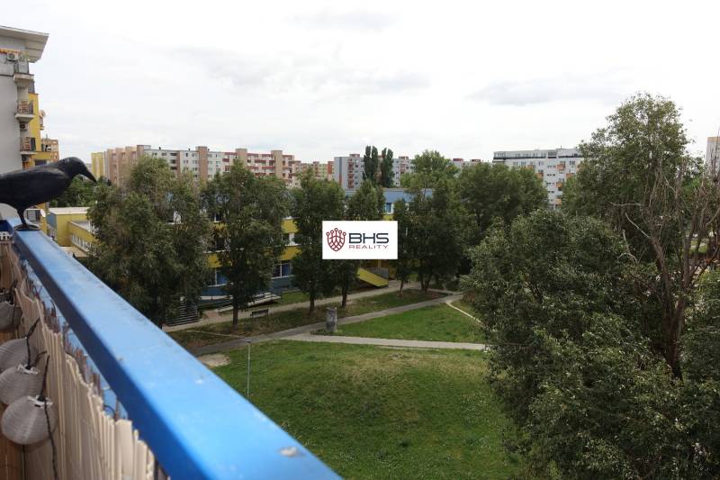 View from the balcony in Bratislava - Podunajské Biskupice on Kazanská Street, surrounded by greenery.