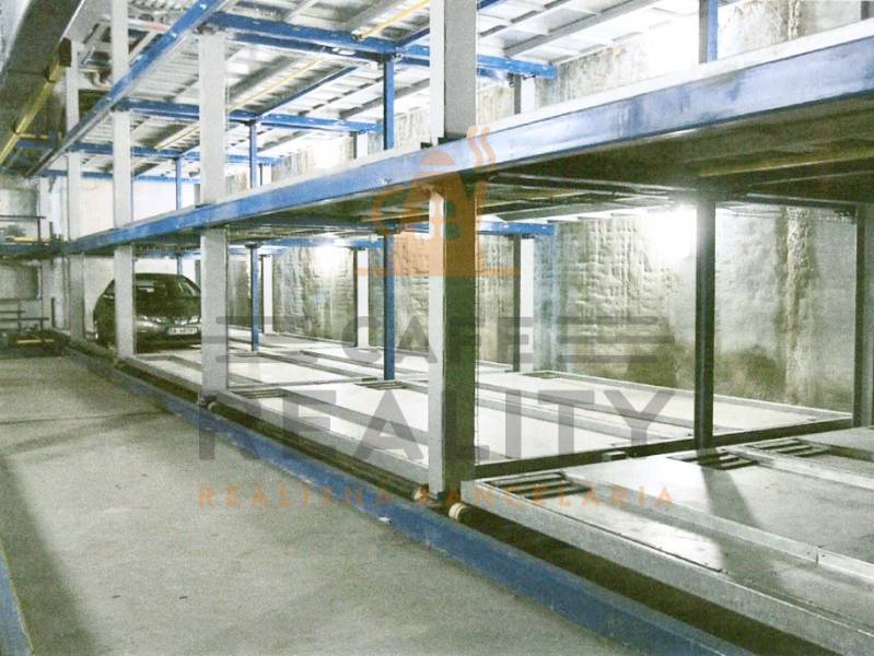 A multi-level parking lot with parked cars offers an efficient solution for storage spaces.