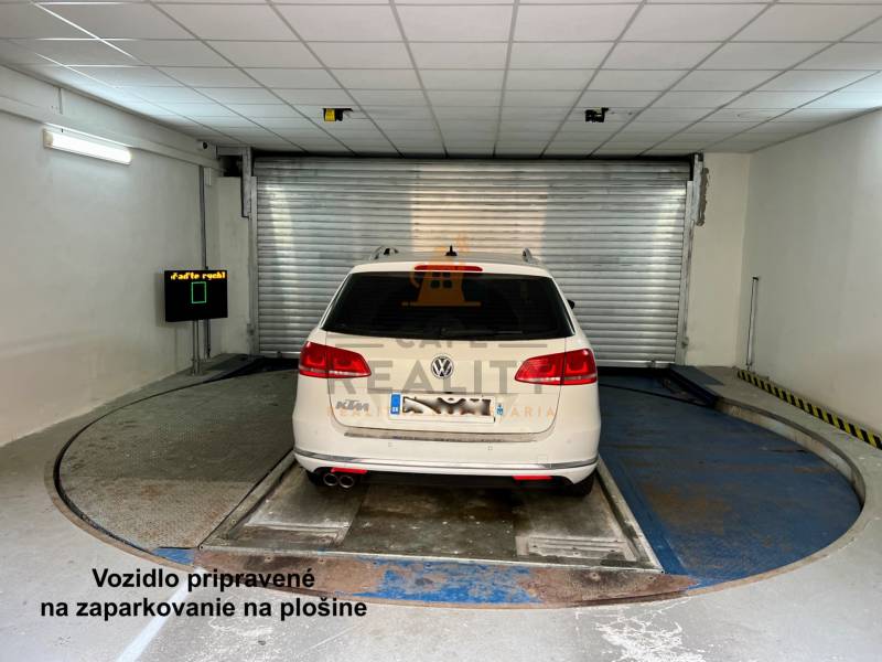 A car parked on a turntable in the garage.