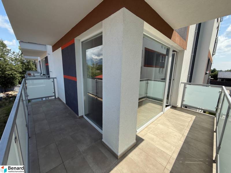 A balcony in a 3-room apartment on Hurbanova Street in Poprad with glass railings.